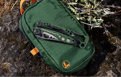 Translation missing: de.A variety of Leatherman tools in different styles are arranged on a vibrant red surface