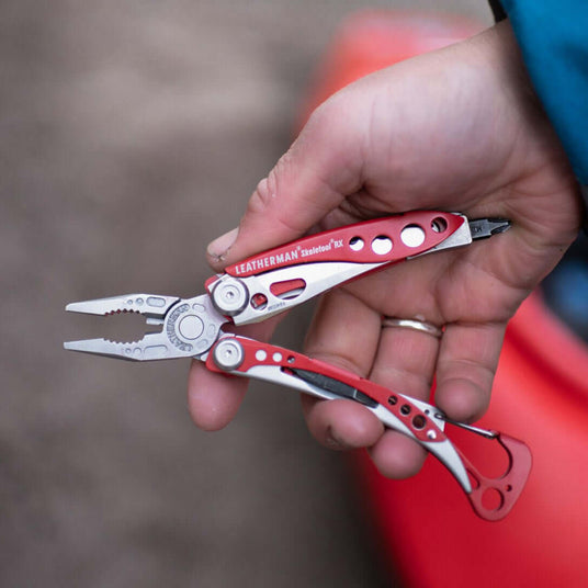 Translation missing: en.Person holding an open Skeletool RX with pliers partially opened
