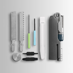 Translation missing: de.Batch #009: Adapter multitool components laid out, including files, saw, drivers, bits, and main tool body