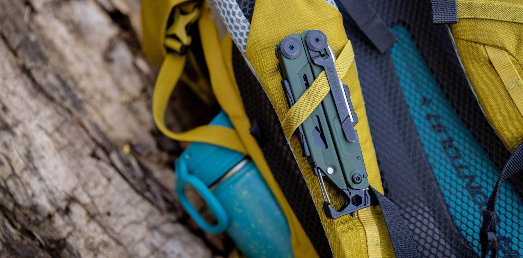 Signal being held in backpacking pack shoulder strap by its pocket clip